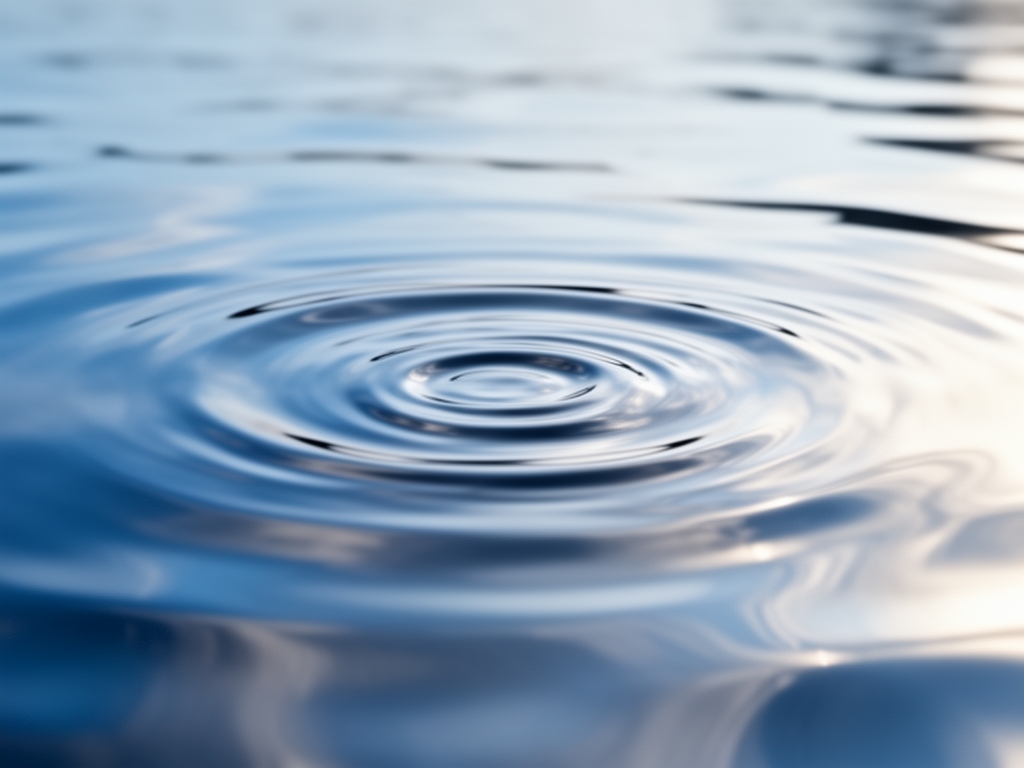 Abstract close-up of still water surface with gentle ripple reflections in cool blue and silver tones, representing mental stillness and clarity